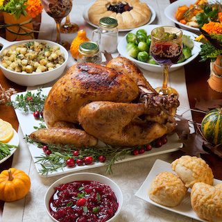 Thanksgiving dinner spread with roasted turkey and side dishes