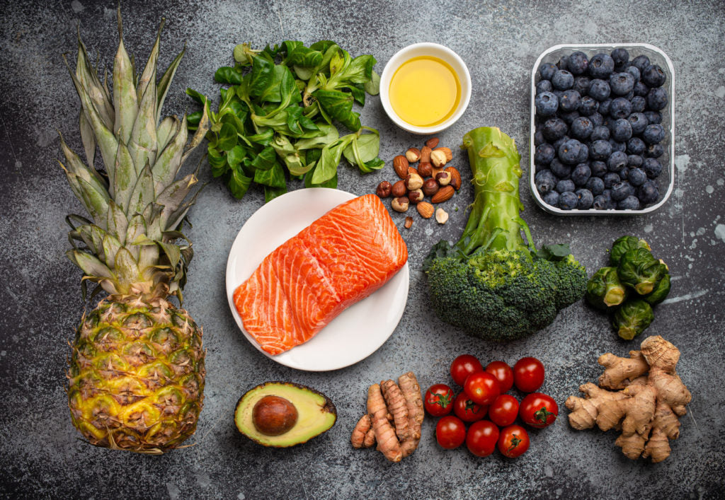 Anti-inflammatory foods including salmon, pineapple, berries, broccoli and avocado
