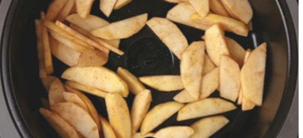 Sliced air fryer apples in a dark bowl