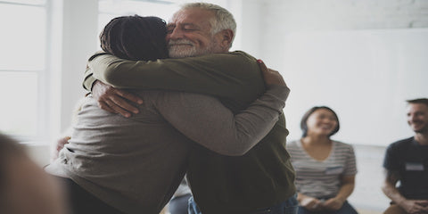 Two people sharing a supportive hug
