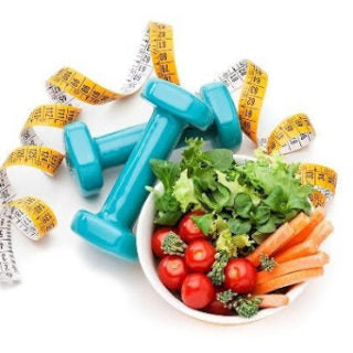 Measuring tape wrapped around dumbbells beside a bowl of vegetables
