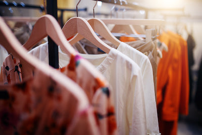 Clothes hanging on a rack in a closet