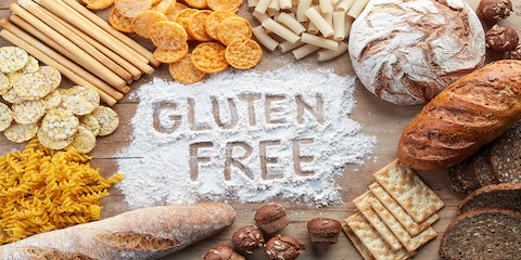 Gluten-free text written in flour surrounded by breads, pasta and grains