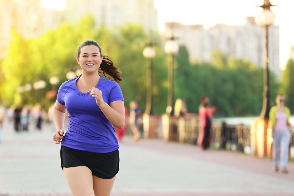 Woman jogging outdoors on a city path