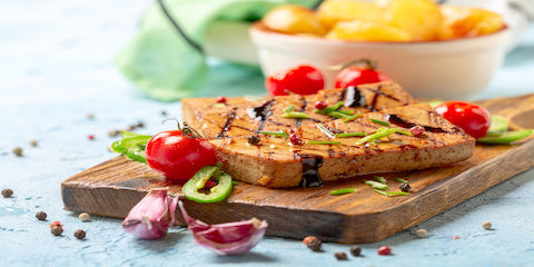 Healthy open-faced toast with fresh vegetables on a wooden board
