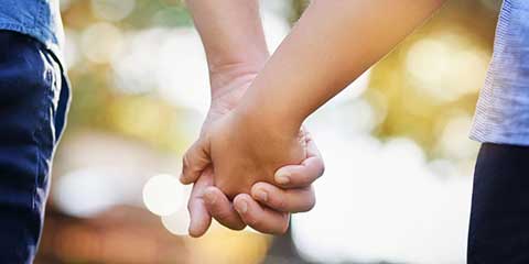 Two people holding hands