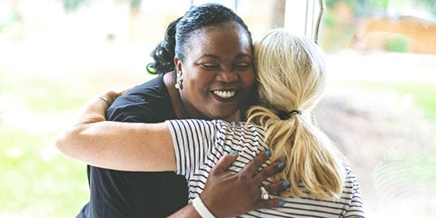 Two friends embracing in a warm hug