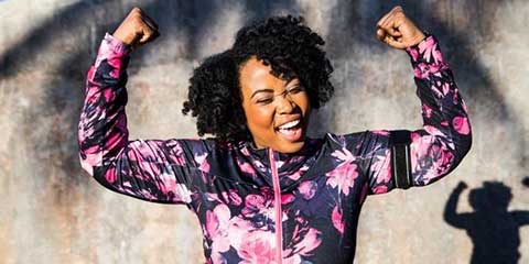 Smiling woman flexing her arms in celebration