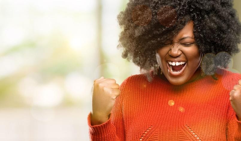 Smiling woman laughing with her eyes closed