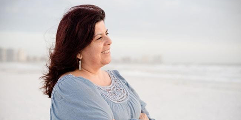 Woman smiling while looking out at the ocean