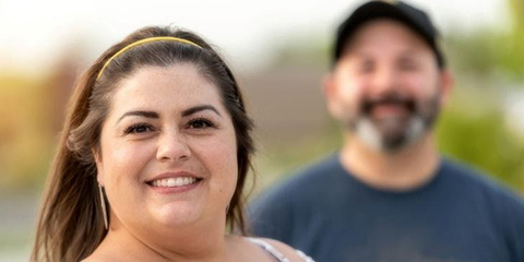 Smiling couple standing close together outdoors