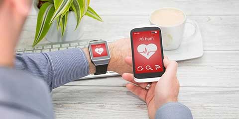 Person tracking health data on a smartphone and smartwatch