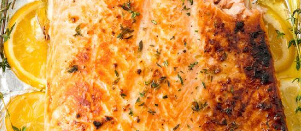 Baked salmon fillet with lemon slices and herbs