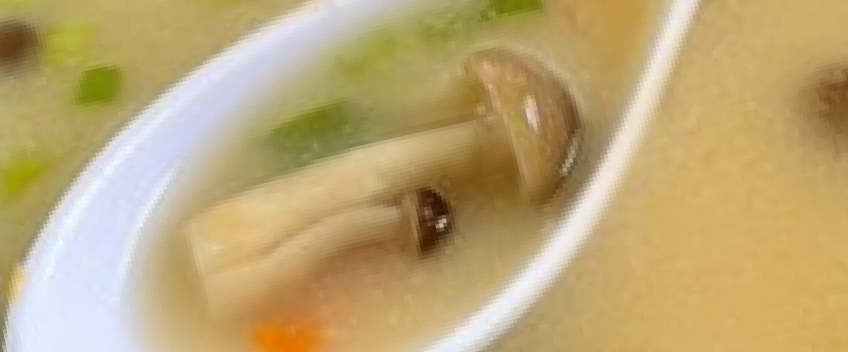 Bowl of miso soup with mushrooms and green onions