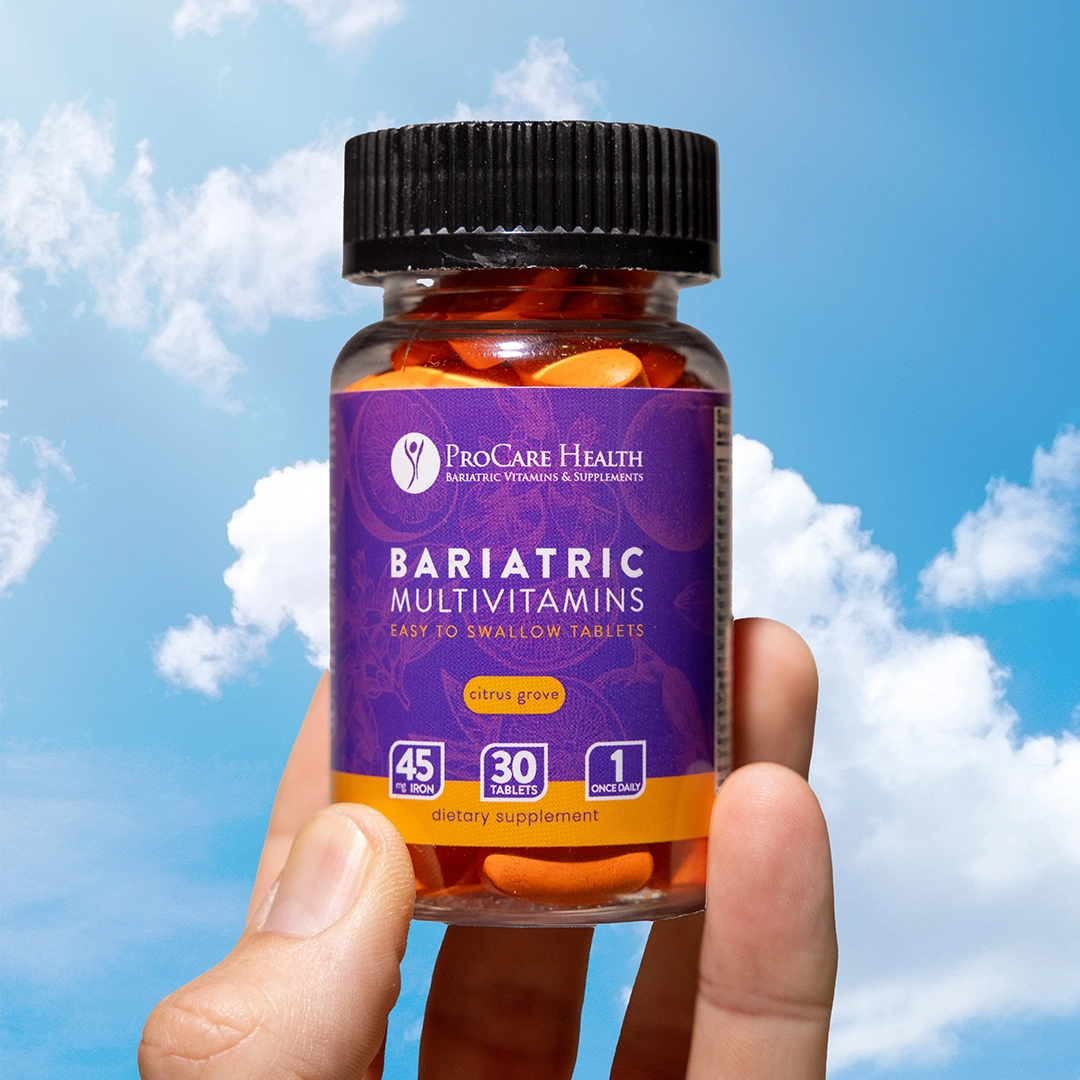 bariatric multivitamin easy to swallow tablets in citrus grove flavor behind held up against a blue sky with clouds