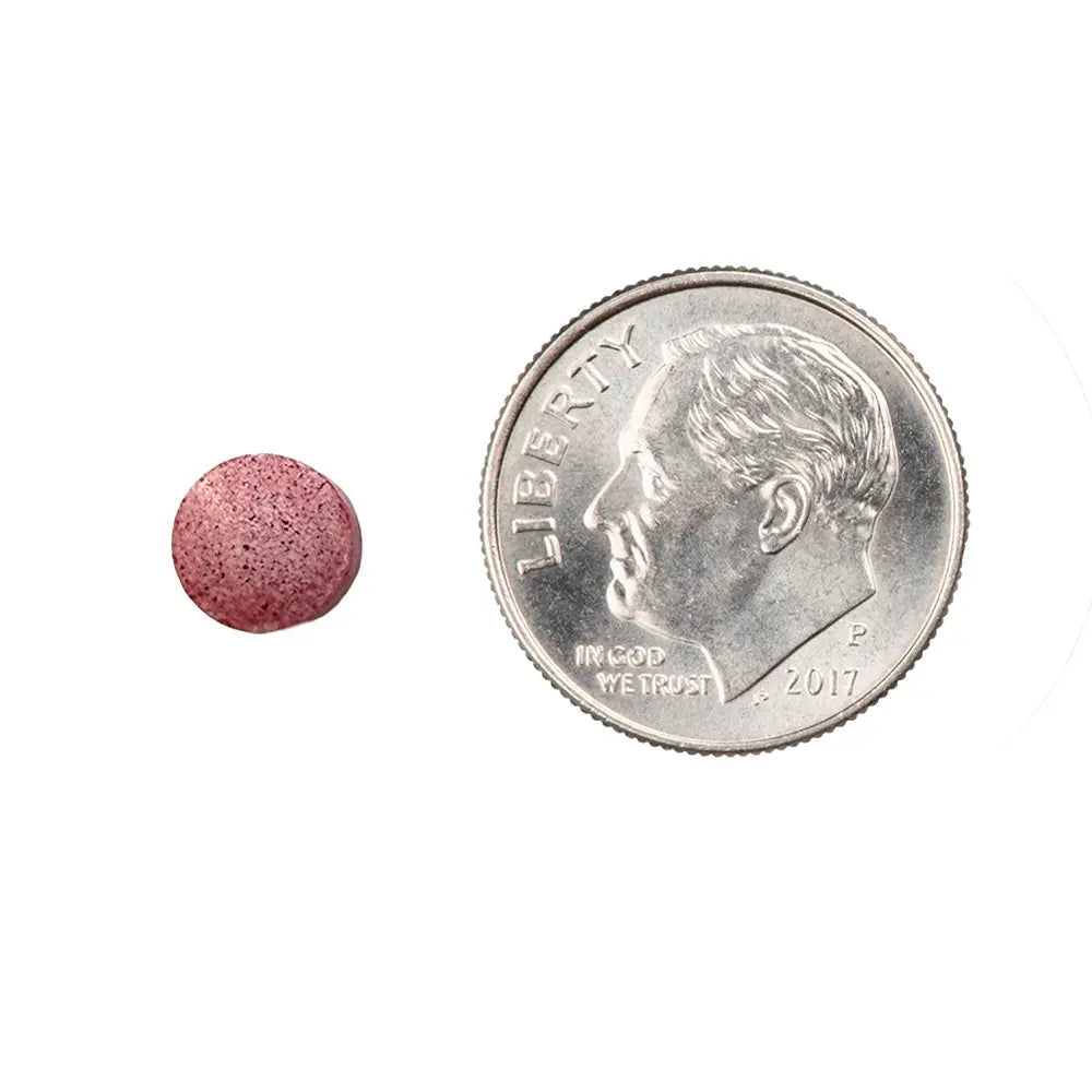B12 Tablet Melt next to a U.S. quarter coin on a white background