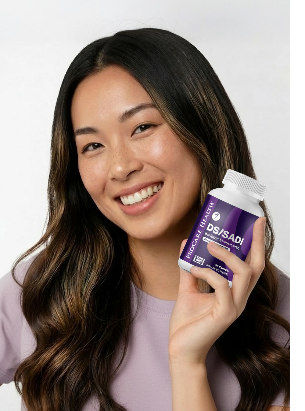 A smiling woman with long dark brown hair holds a white bottle of DSISADI Bariatric Multivitamin supplements in her hand against a clean white background.